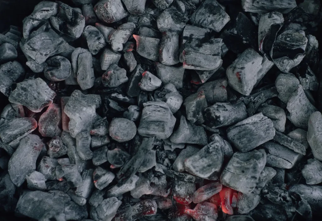 Close-up of black granular activated carbon pellets used in air filters