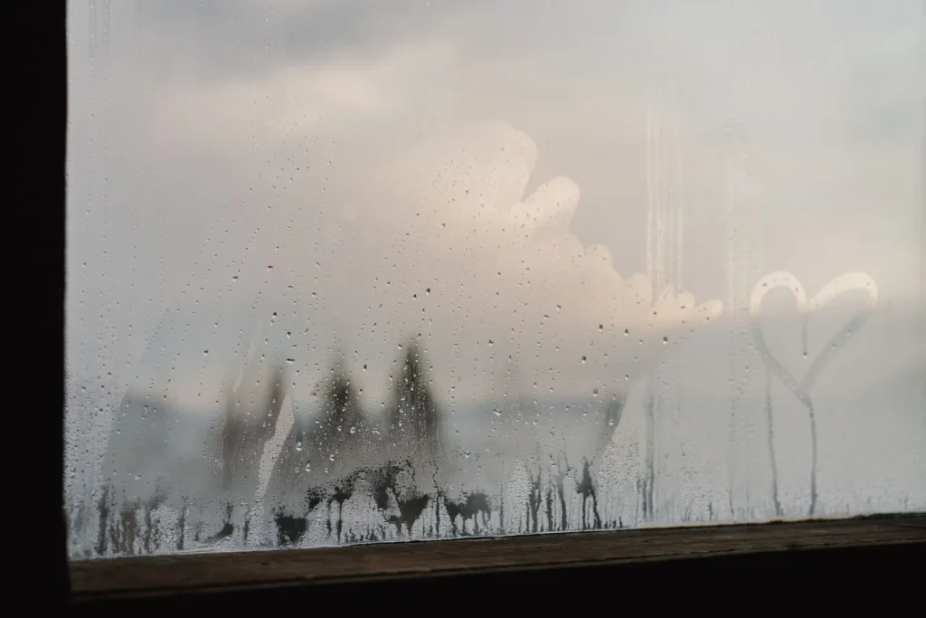Water droplets and fog on a cold window pane on a winter morning