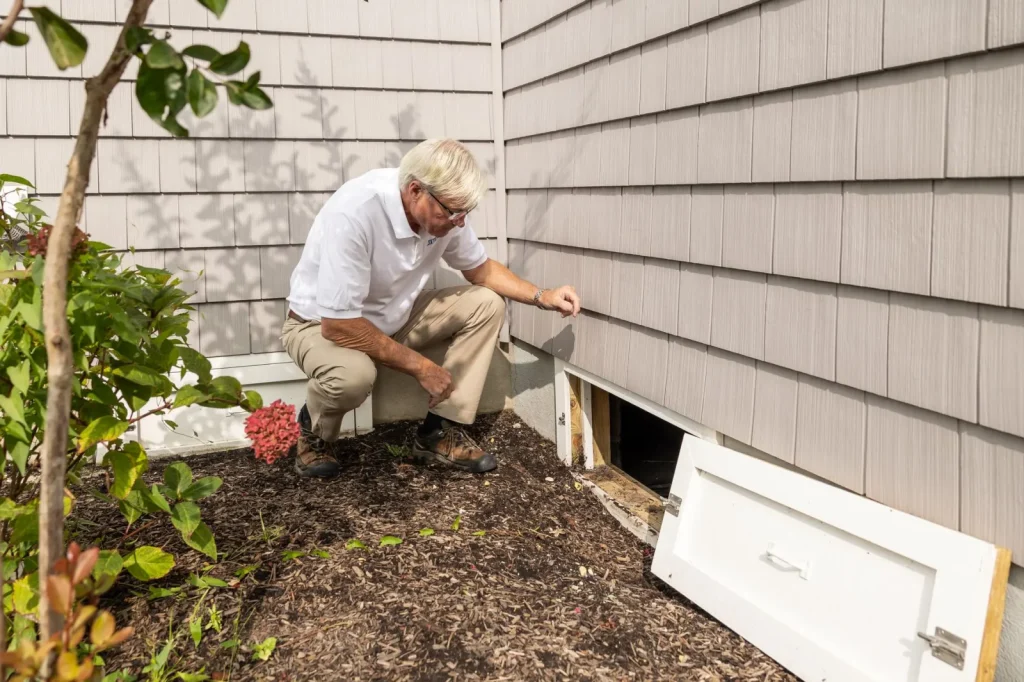 A low-profile dehumidifier installed in an encapsulated crawl space with a drain line