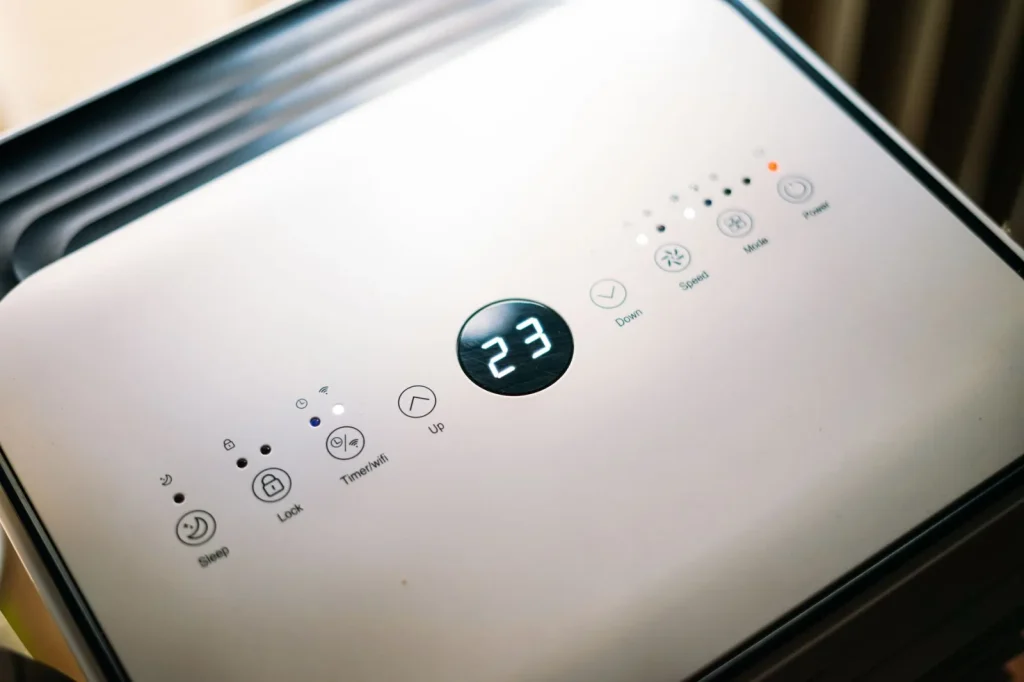 Close-up of a dehumidifier control panel showing the humidistat set to 50 percent