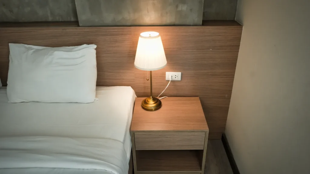 A cool mist evaporative humidifier running quietly on a bedroom side table