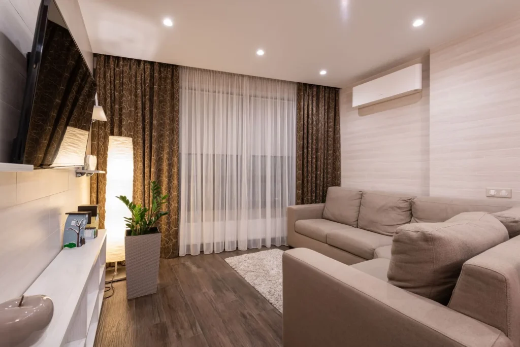 A portable HEPA air purifier running in a home living room