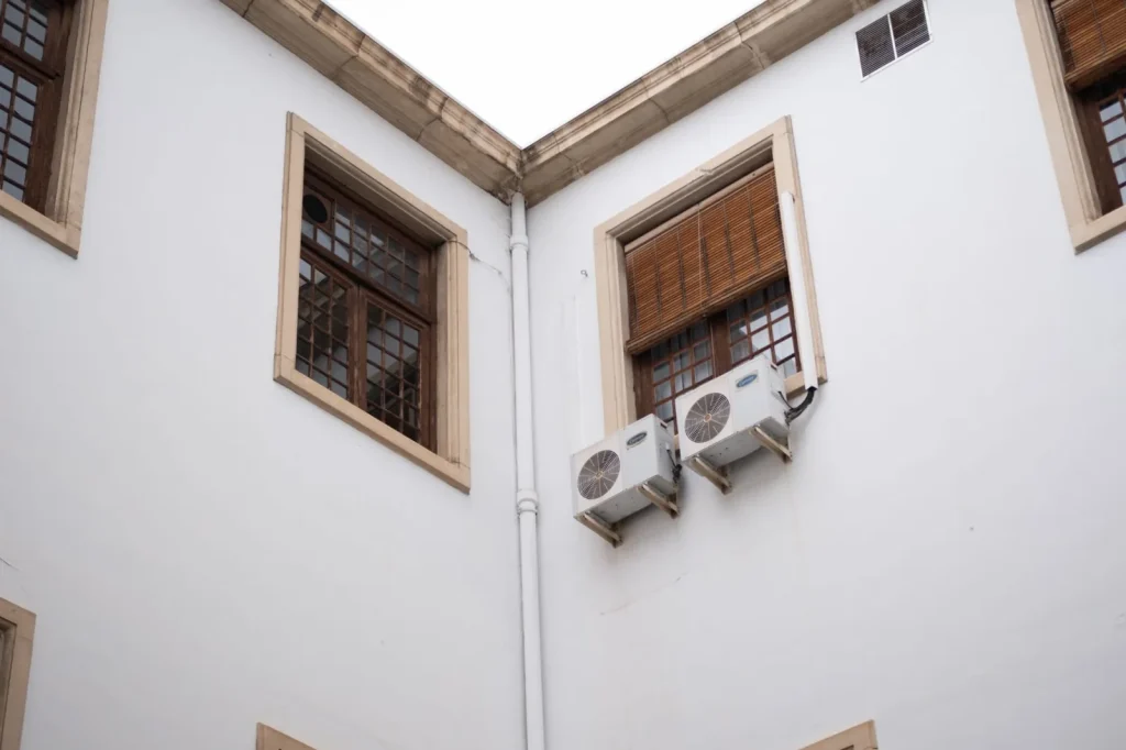 A wall-mounted energy recovery ventilator with insulated ducts in a home mechanical room