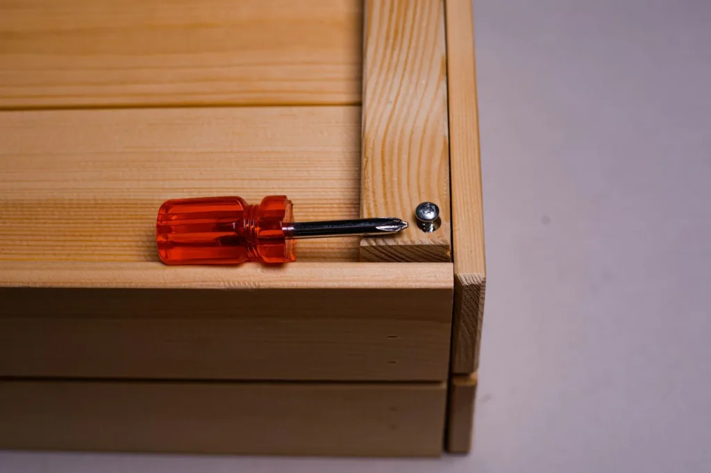 The back of an analog hygrometer showing the small recessed calibration screw used to set the offset