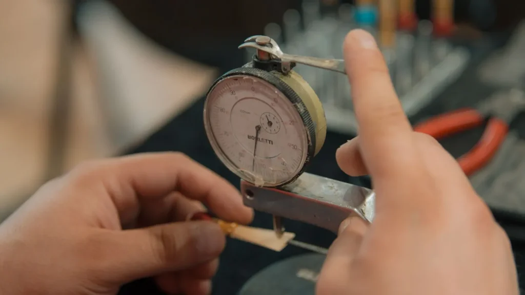 An analog hygrometer with a needle pointing to the relative humidity percentage on a printed dial