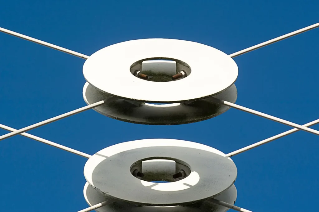 Open humidifier base showing the small metal transducer disc coated with white mineral scale