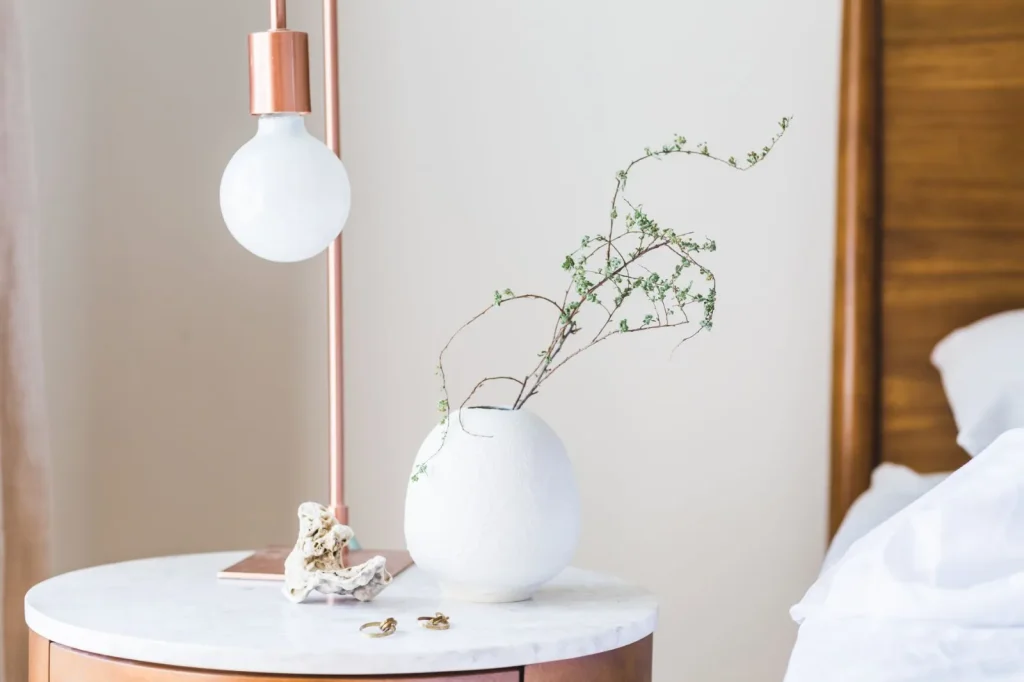 A cool-mist ultrasonic humidifier running on a bedroom nightstand at night