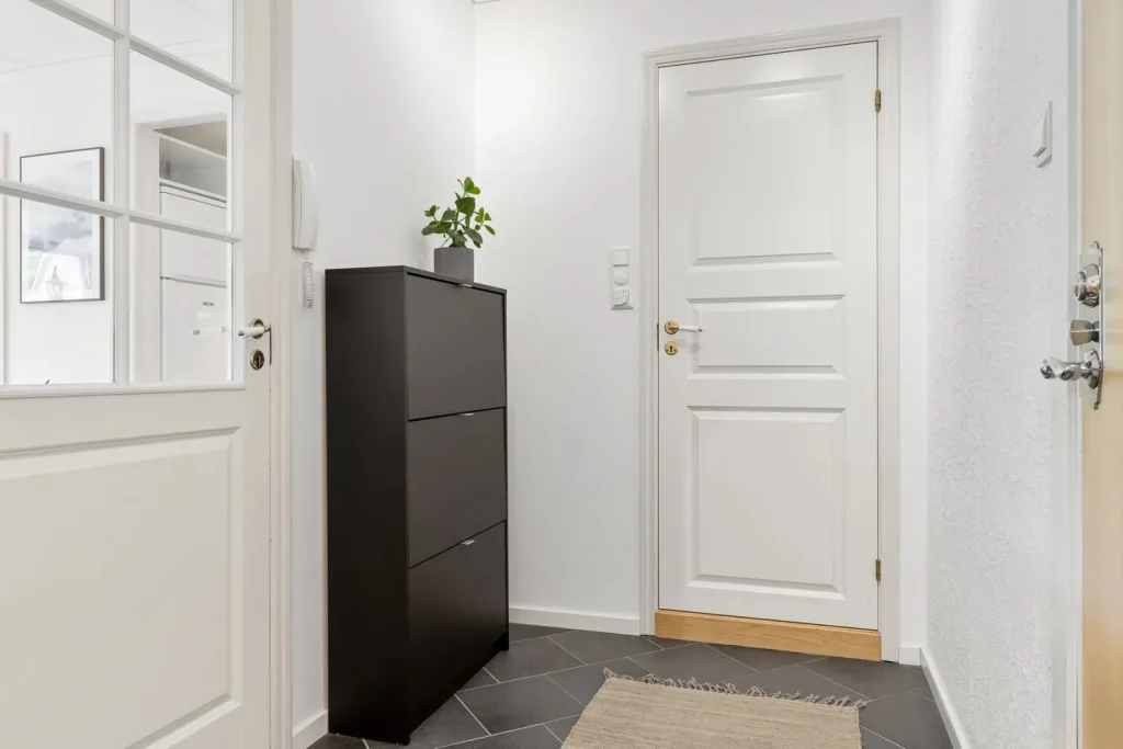 Fine white mineral dust settled on a dark wooden dresser near a humidifier