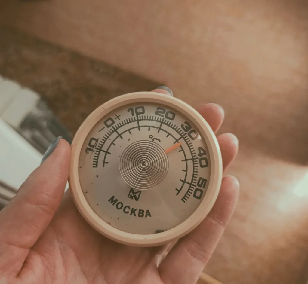 A small digital hygrometer showing 45 percent humidity mounted on a nursery wall