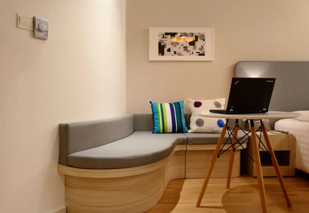 A compact bedroom humidifier releasing a fine mist into dry indoor air