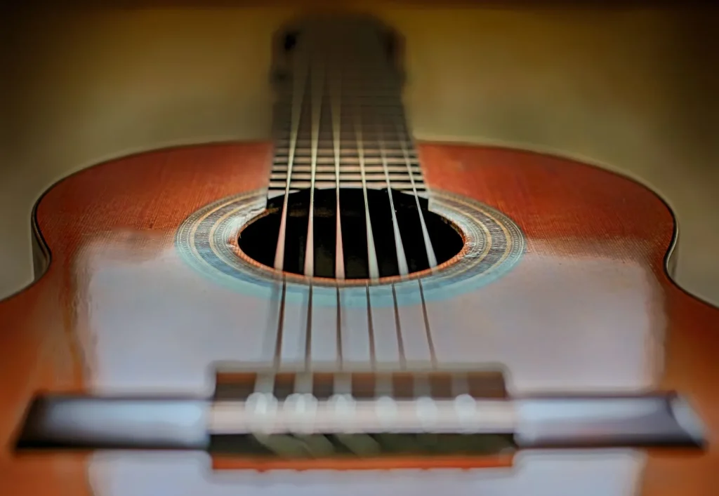 A two-way humidity pack resting in the soundhole of a solid-wood acoustic guitar