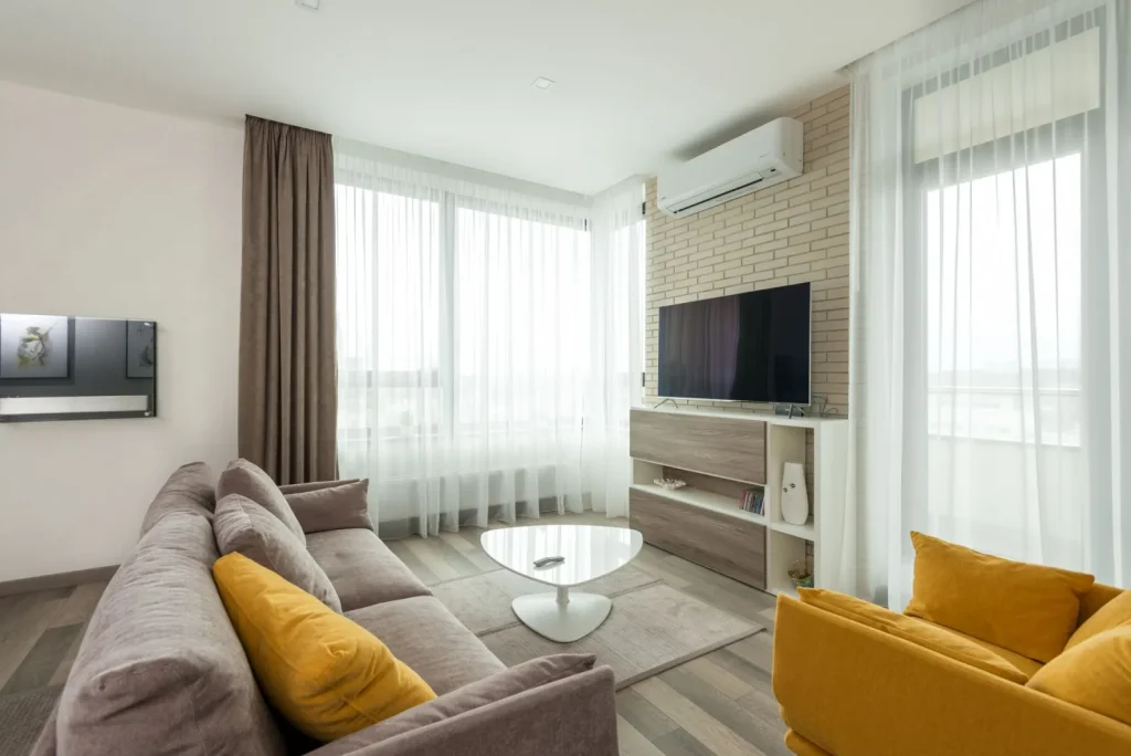 A portable HEPA air purifier running in a living room to capture airborne pet dander