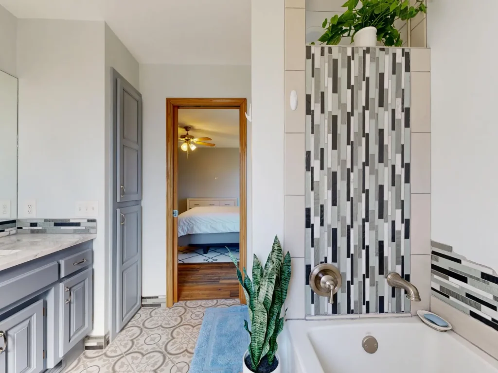 A ceiling extractor fan running above a steamy tiled shower