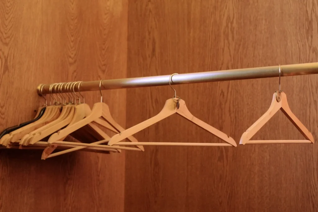 A tidy closet with clothes spaced out on hangers so air can circulate freely between them