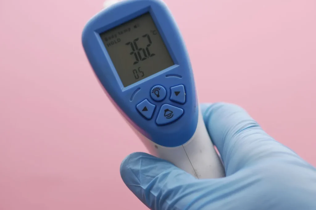 A small digital hygrometer on a shelf showing an indoor relative humidity reading