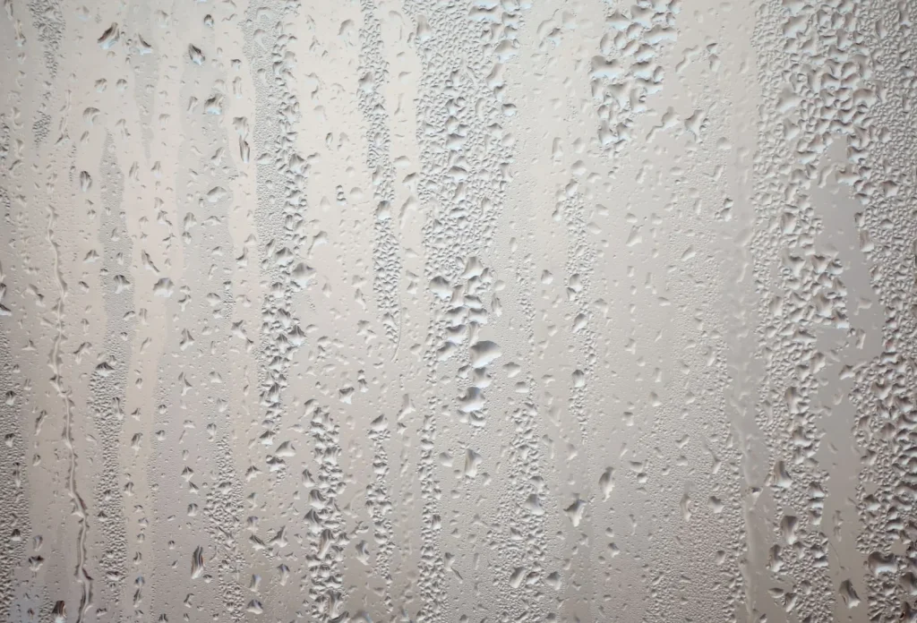 Interior condensation pooling on a window sill, a common sign of poor home ventilation