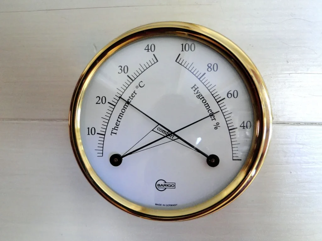 A small digital hygrometer displaying bedroom relative humidity around 45 percent