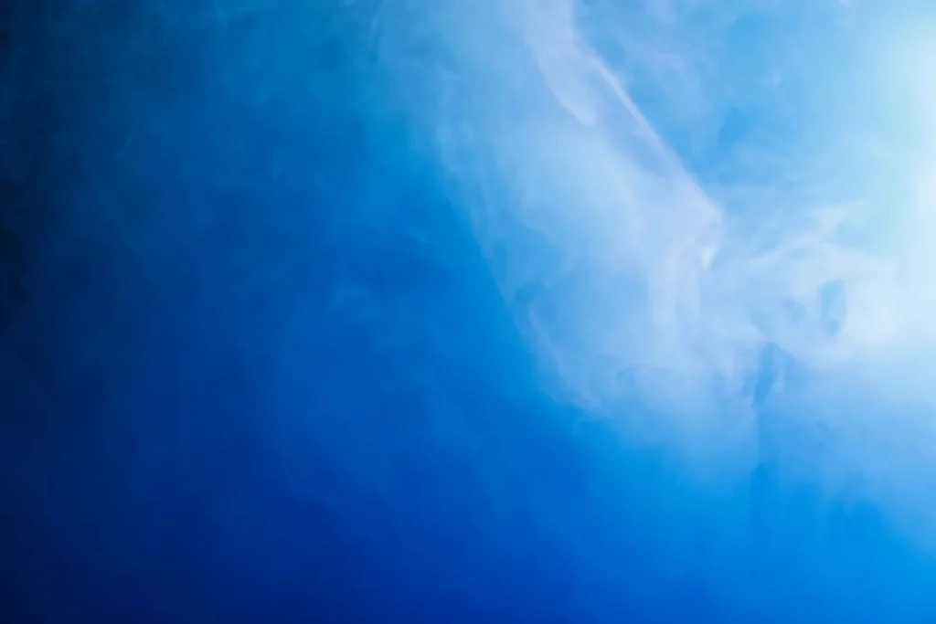 A cool mist humidifier producing fine fog on a dresser in a child's room