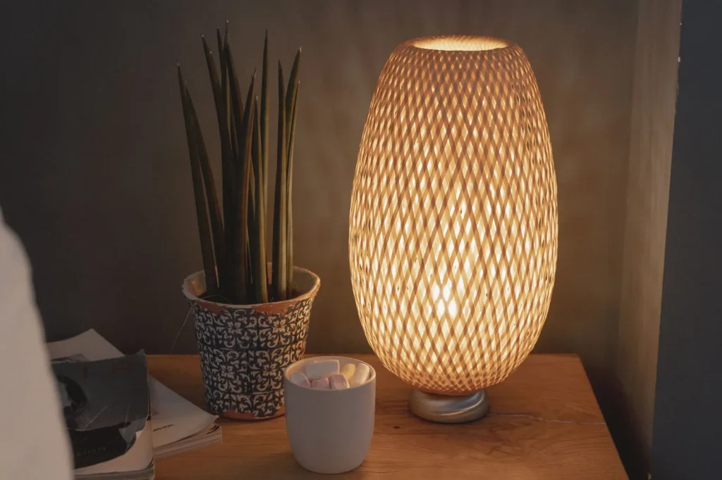 A portable cool mist humidifier running on a bedroom nightstand