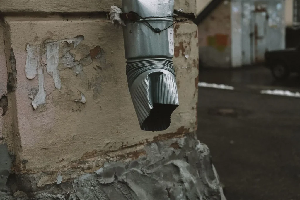 A dehumidifier connected to a drainage hose running toward a floor drain for continuous operation