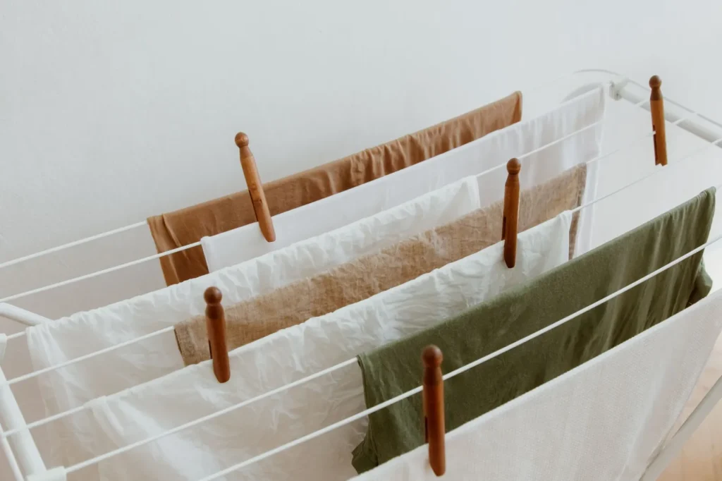 Clothes air-drying on a folding rack in a warm living room to add winter humidity